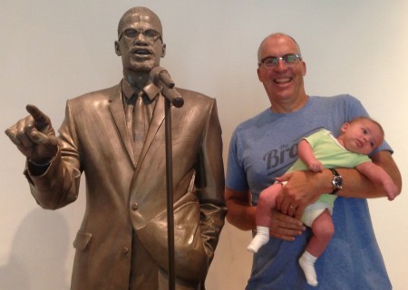 Malcolm X, Maeve and me. Life size statue of Malcolm X at the Shabazz Center at the Audubon Ballroom - the site where Malcolm X was assassinated.